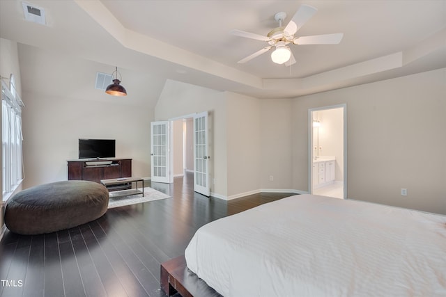 bedroom featuring a raised ceiling and dark hardwood / wood-style floors