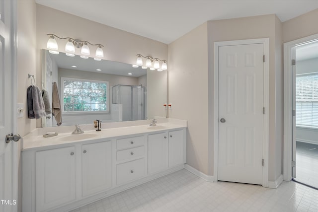 bathroom featuring vanity, an enclosed shower, and a wealth of natural light