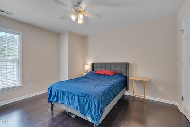 bedroom with dark hardwood / wood-style flooring and ceiling fan