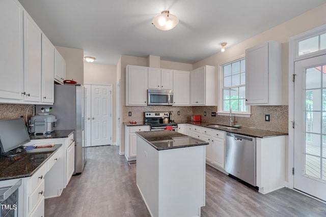 106 Dairy Ct, Chapel Hill, NC 27516 - kitchen with stainless steel appliances, a sink, wood finished floors, and decorative backsplash