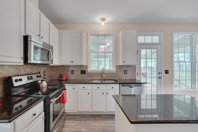 106 Dairy Ct, Chapel Hill, NC 27516 - kitchen with appliances with stainless steel finishes, a sink, white cabinets, and plenty of natural light
