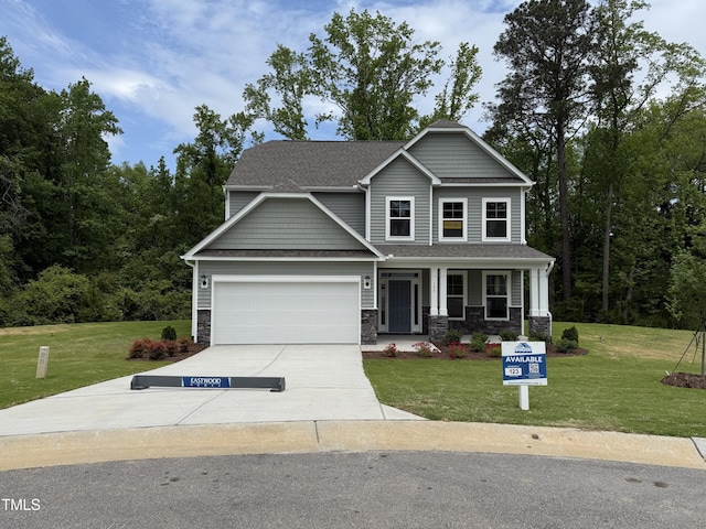 129 Stallion Way, Benson, NC 27504 - craftsman-style house with concrete driveway, a front lawn, an attached garage, and stone siding