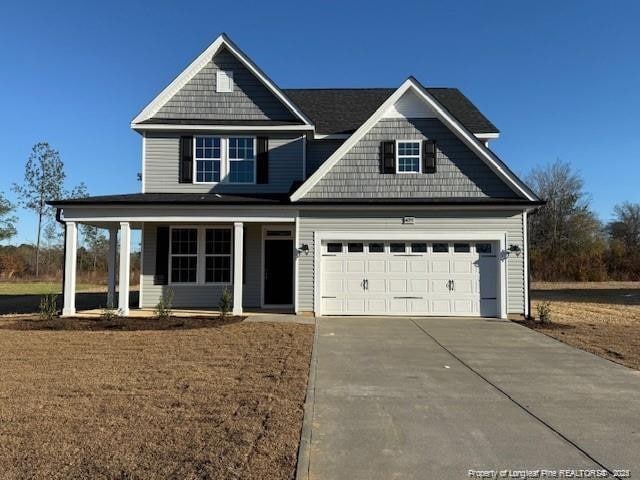 craftsman inspired home featuring a porch and a garage