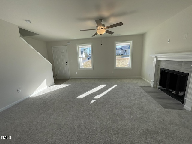 unfurnished living room featuring ceiling fan and light carpet