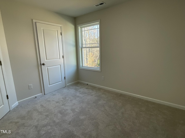 empty room featuring light carpet