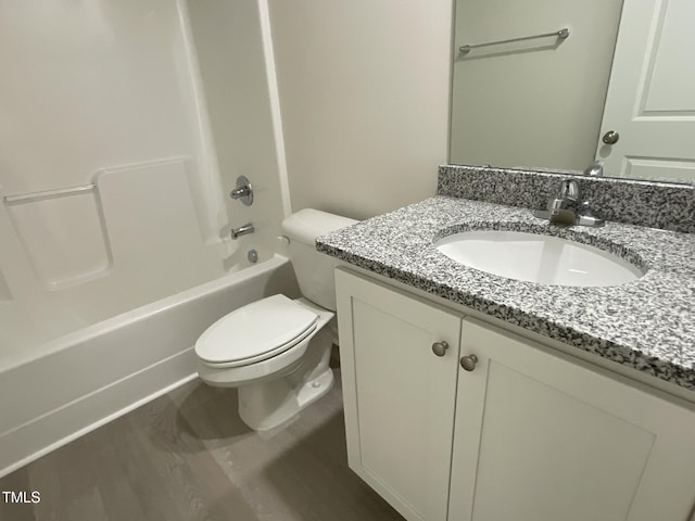 full bathroom with bathtub / shower combination, hardwood / wood-style floors, vanity, and toilet