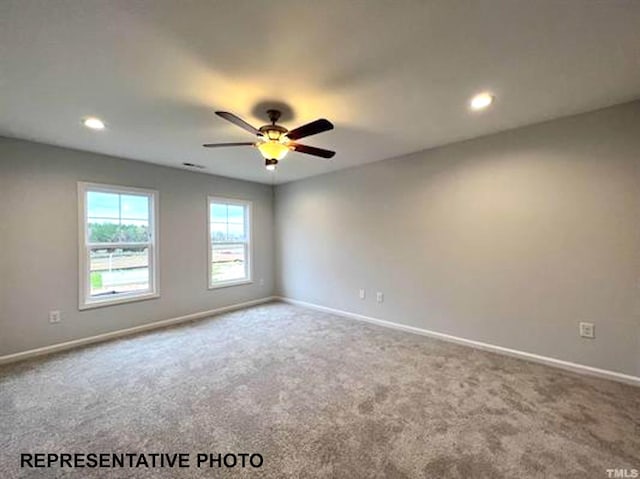 unfurnished room featuring baseboards, carpet floors, and ceiling fan