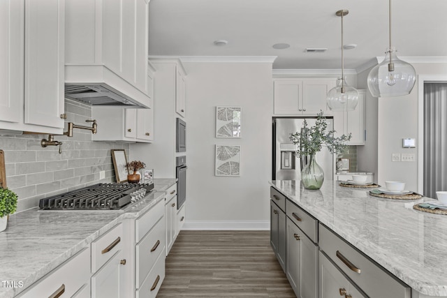 kitchen featuring crown molding, stainless steel appliances, visible vents, white cabinets, and light stone countertops