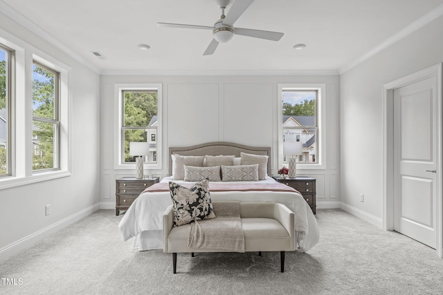 bedroom featuring crown molding, multiple windows, and light colored carpet