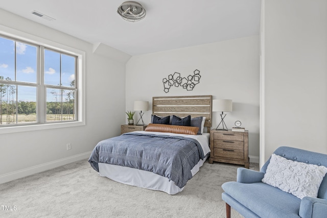 carpeted bedroom featuring lofted ceiling, visible vents, and baseboards