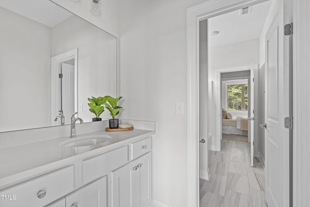 bathroom with ensuite bathroom and vanity