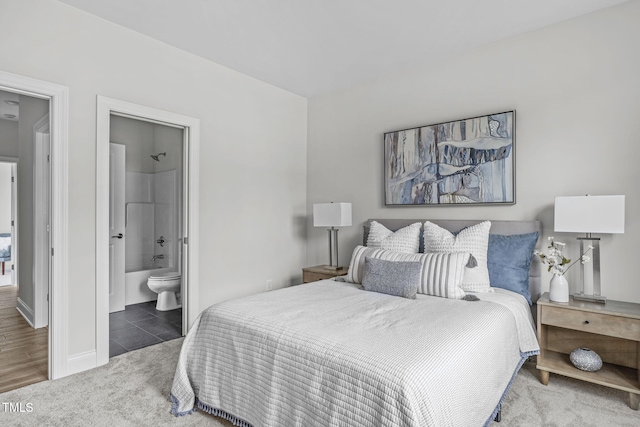 carpeted bedroom featuring tile patterned floors and ensuite bathroom