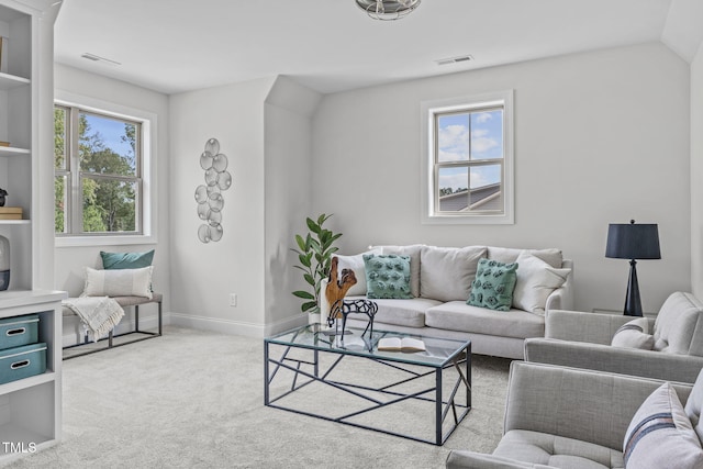 living area with carpet, visible vents, and baseboards