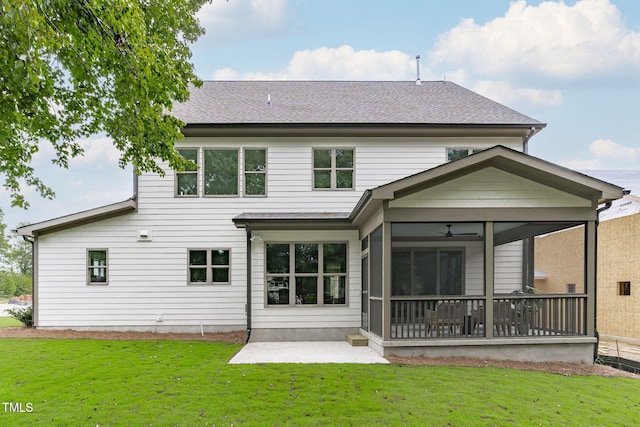 back of property with a shingled roof, a sunroom, a yard, and a patio