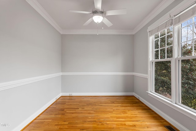 spare room featuring light hardwood / wood-style floors, ceiling fan, and ornamental molding