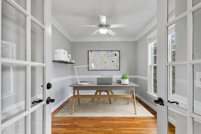 home office with wood-type flooring, ornamental molding, ceiling fan, and french doors