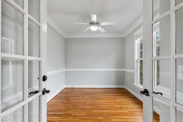 spare room with ceiling fan, ornamental molding, french doors, and light wood-type flooring