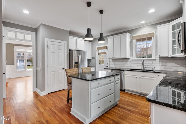 kitchen featuring a kitchen island, white cabinetry, and pendant lighting