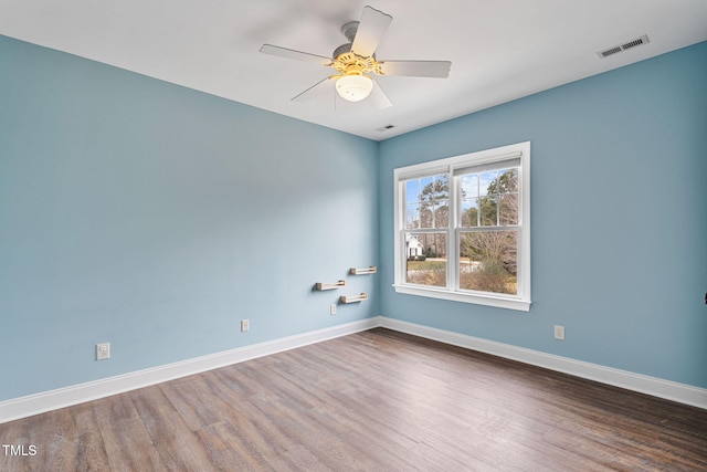 empty room with ceiling fan and wood-type flooring