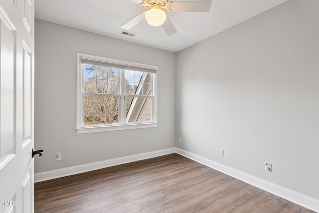 unfurnished room with ceiling fan and dark hardwood / wood-style floors