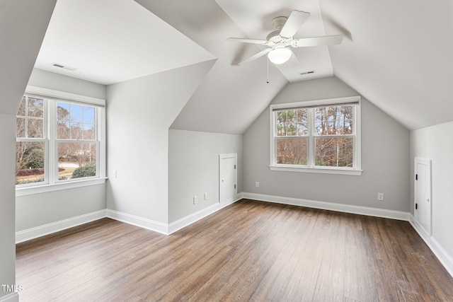 additional living space with ceiling fan, wood-type flooring, and lofted ceiling