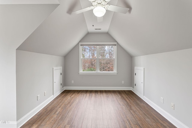 bonus room with ceiling fan, dark wood-type flooring, and lofted ceiling