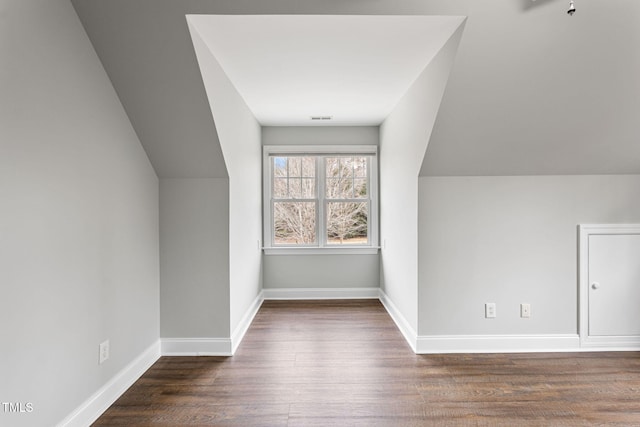 bonus room featuring dark hardwood / wood-style floors and lofted ceiling