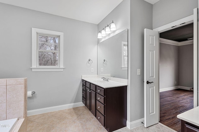 bathroom featuring crown molding, tile patterned floors, and vanity