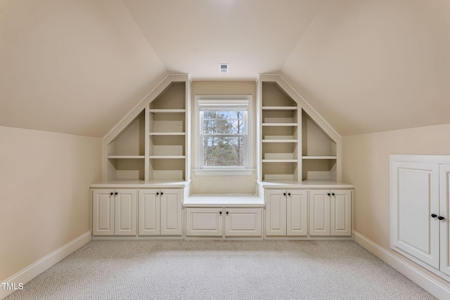 bonus room with light carpet and lofted ceiling