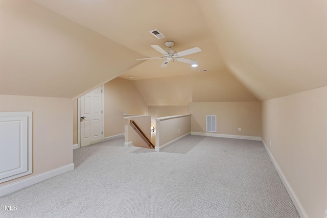 bonus room with vaulted ceiling, ceiling fan, and light colored carpet