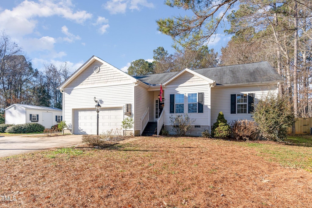 ranch-style house with a garage and a front lawn