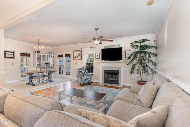 living room with a high end fireplace, light hardwood / wood-style floors, and ornamental molding