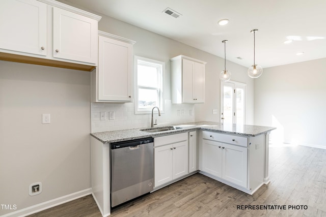 kitchen featuring sink, white cabinets, hanging light fixtures, stainless steel dishwasher, and light stone countertops