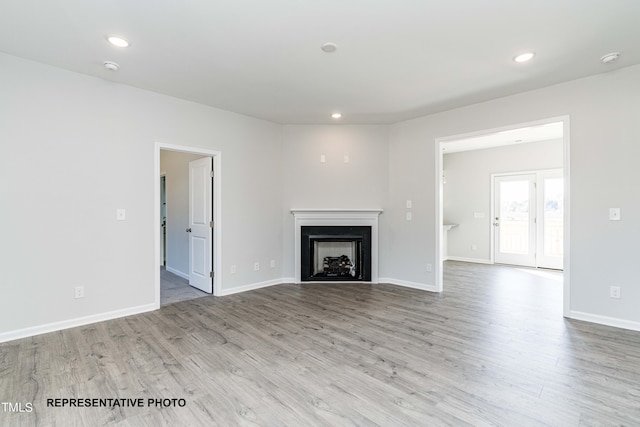 unfurnished living room with light hardwood / wood-style floors