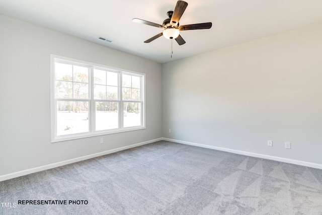 spare room with carpet flooring and ceiling fan