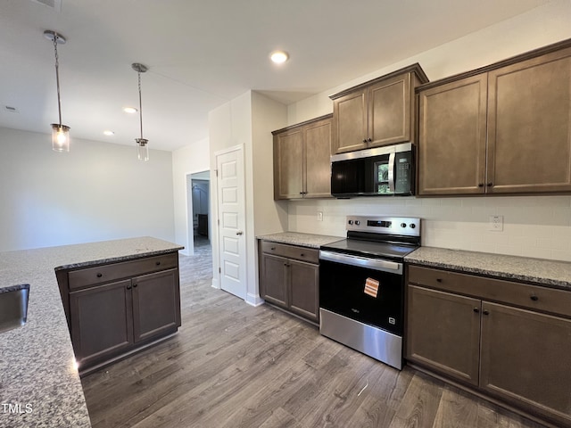 286 Longbow Dr, Middlesex, NC 27557 - kitchen featuring appliances with stainless steel finishes, dark wood finished floors, backsplash, recessed lighting, and light stone countertops