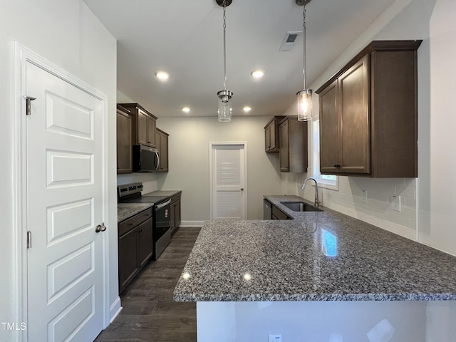 286 Longbow Dr, Middlesex, NC 27557 - kitchen featuring appliances with stainless steel finishes, a sink, dark brown cabinetry, dark wood-type flooring, and recessed lighting