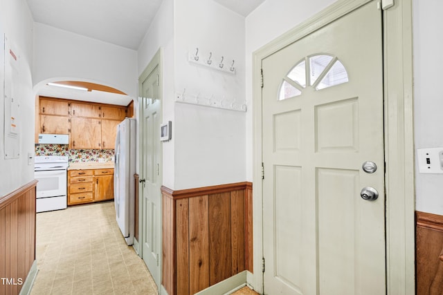 foyer featuring wooden walls