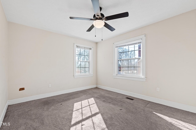 carpeted spare room with ceiling fan