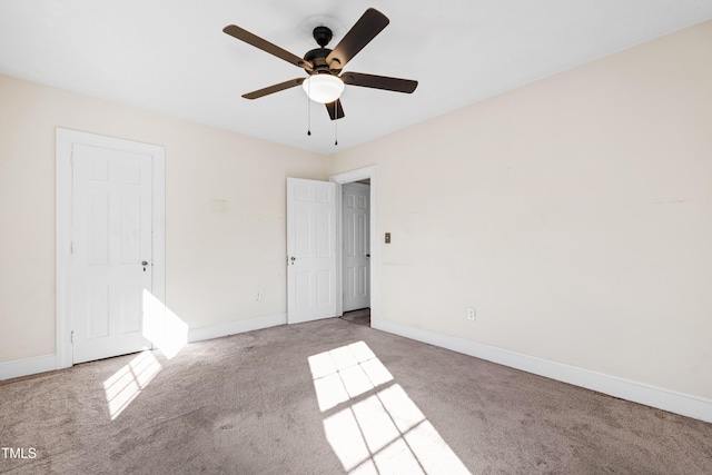 unfurnished room with light colored carpet and ceiling fan