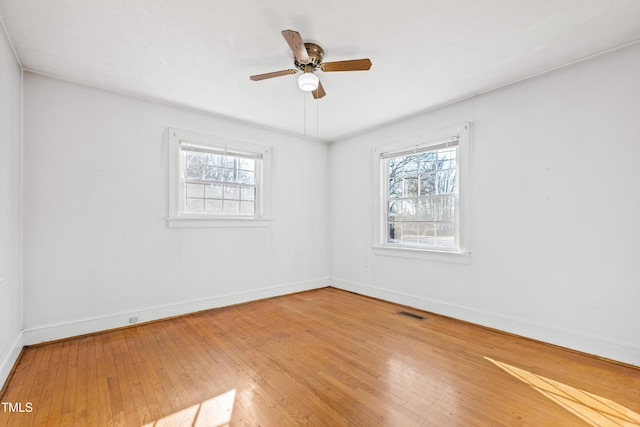 empty room featuring wood-type flooring and ceiling fan