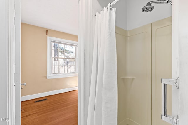 bathroom featuring a shower with curtain and hardwood / wood-style flooring