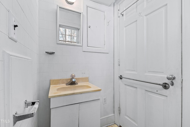 bathroom with vanity and tile walls