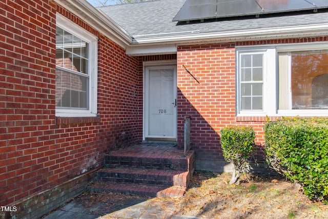 doorway to property featuring solar panels