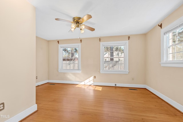 spare room with ceiling fan, light hardwood / wood-style flooring, and a healthy amount of sunlight