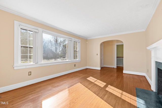 unfurnished living room featuring crown molding and wood-type flooring