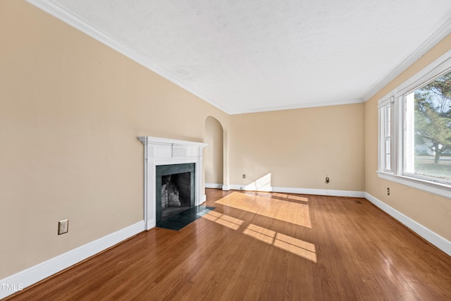 unfurnished living room with ornamental molding, hardwood / wood-style floors, and a textured ceiling