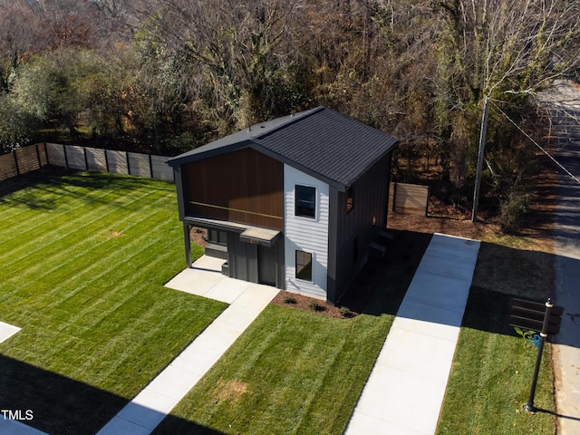 view of outbuilding featuring a yard