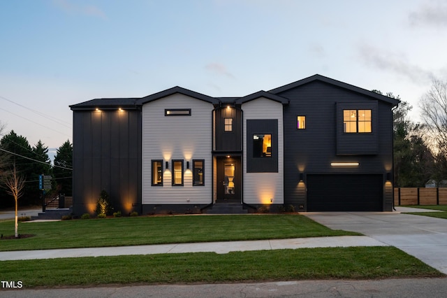 view of front of home featuring a garage and a yard