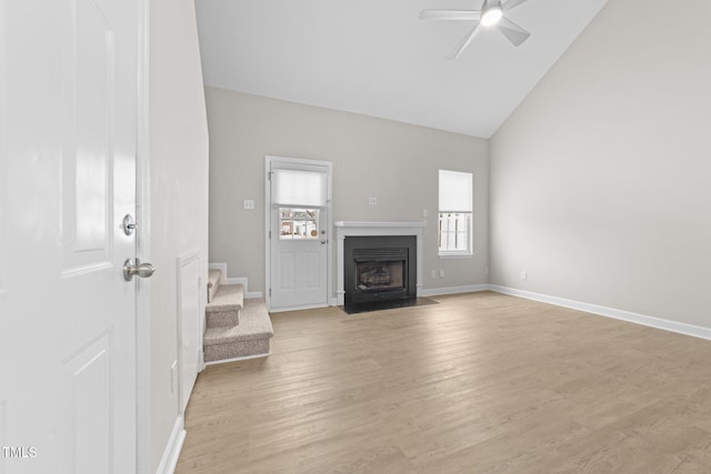 unfurnished living room with high vaulted ceiling, ceiling fan, and light hardwood / wood-style floors